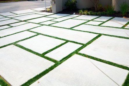 Pavers with artificial grass in between installed at a home in South Florida