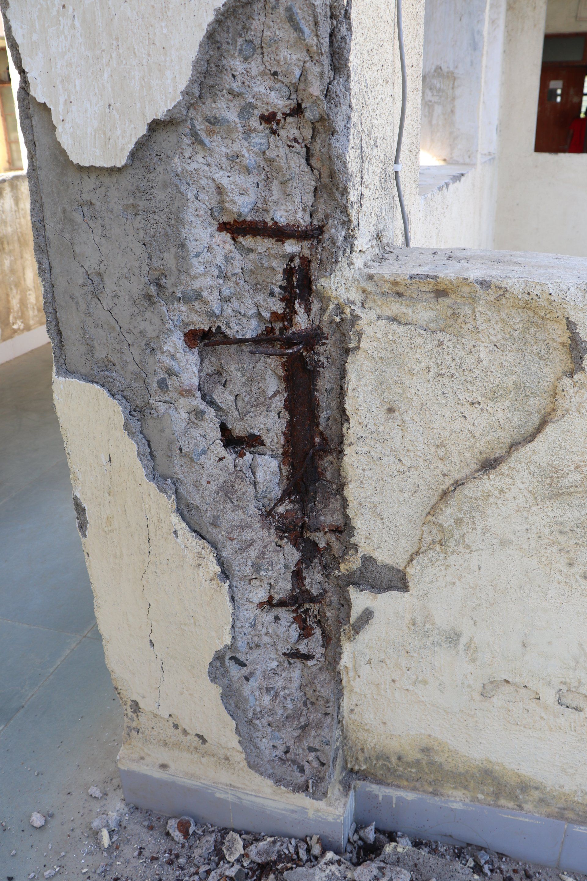 Concrete pillar showing concrete spalling with rebar rusting