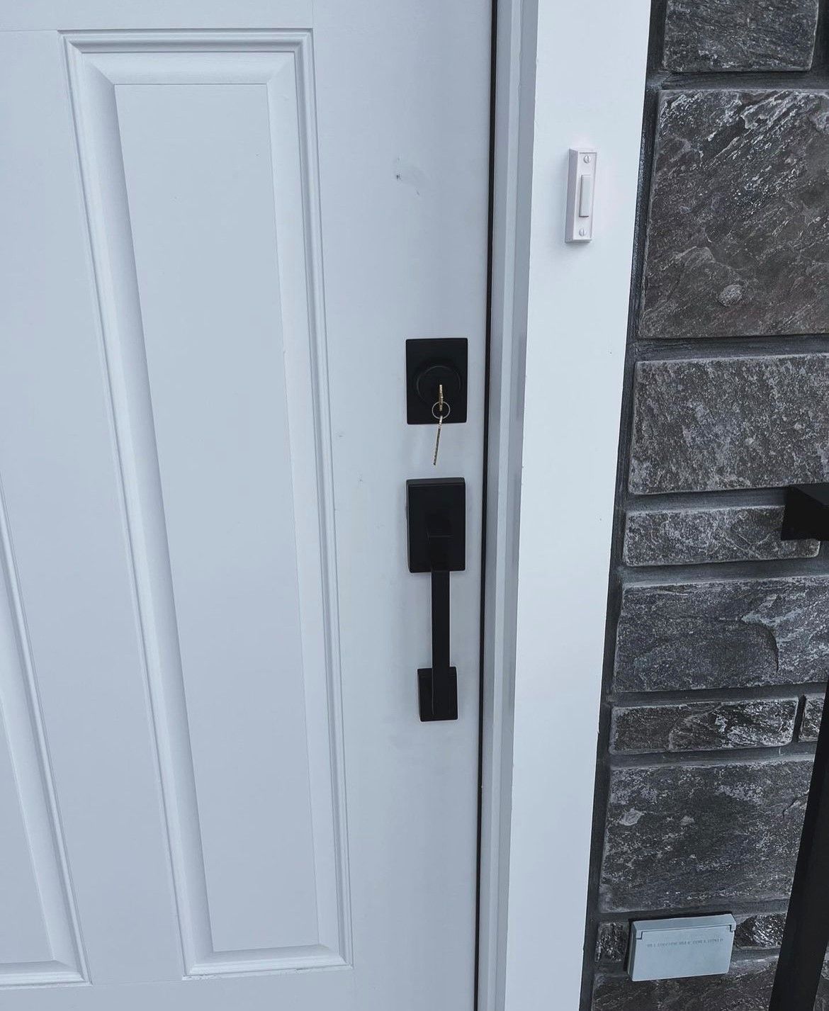 A man in a red hoodie is reaching into a shelf in a van.