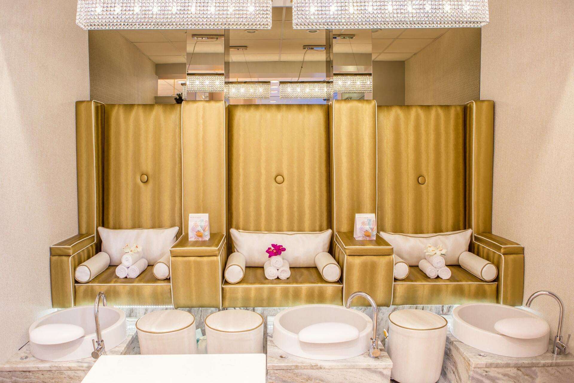 spa with gold chairs and foot baths for pedicures