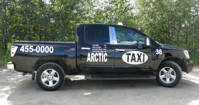 Arctic taxi truck service going to a road in the mountains