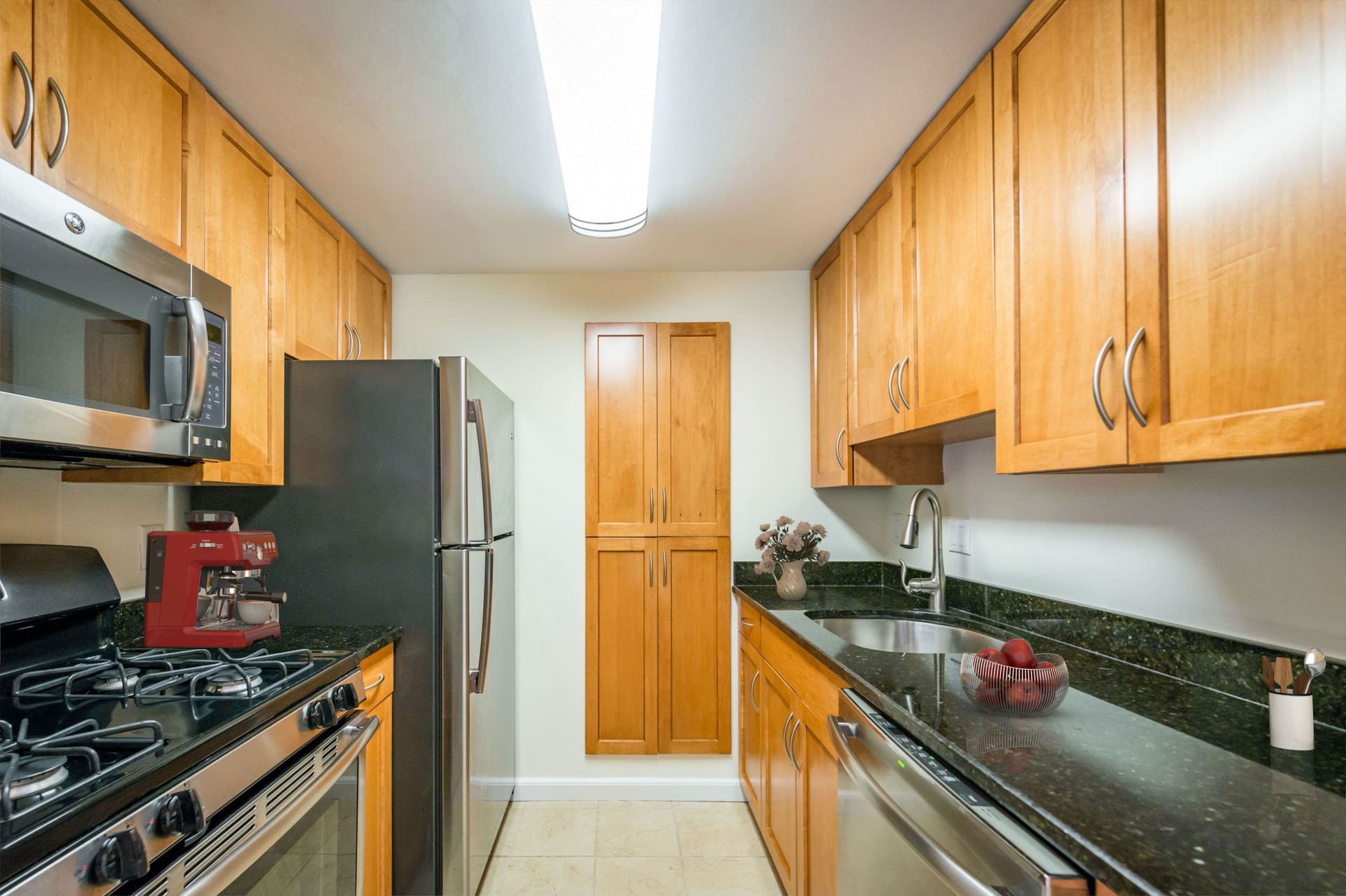 A kitchen with stainless steel appliances and wooden cabinets