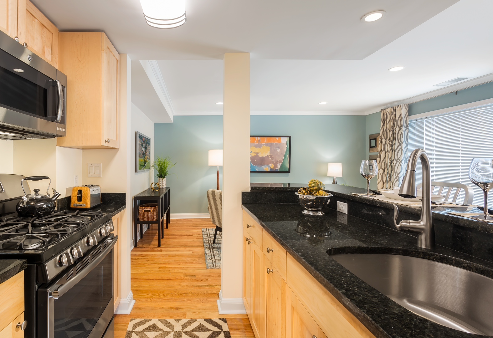 A kitchen with stainless steel appliances and granite counter tops