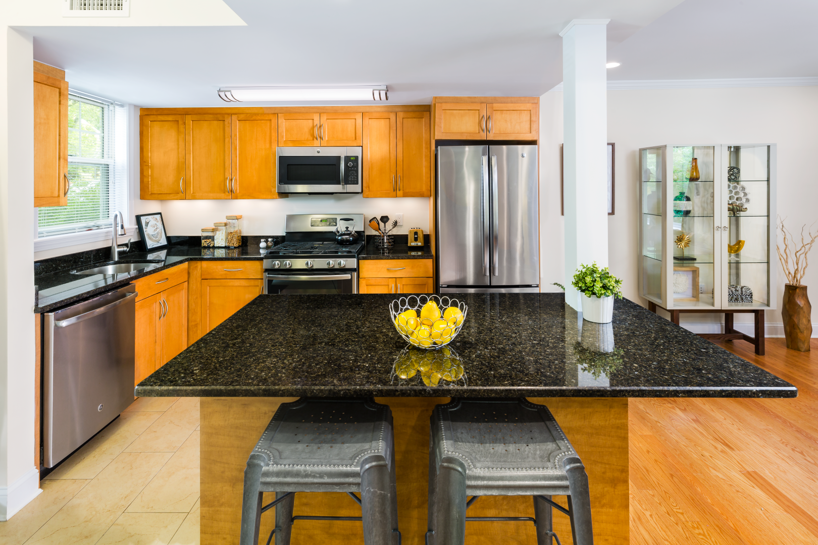 A kitchen with granite counter tops and stainless steel appliances