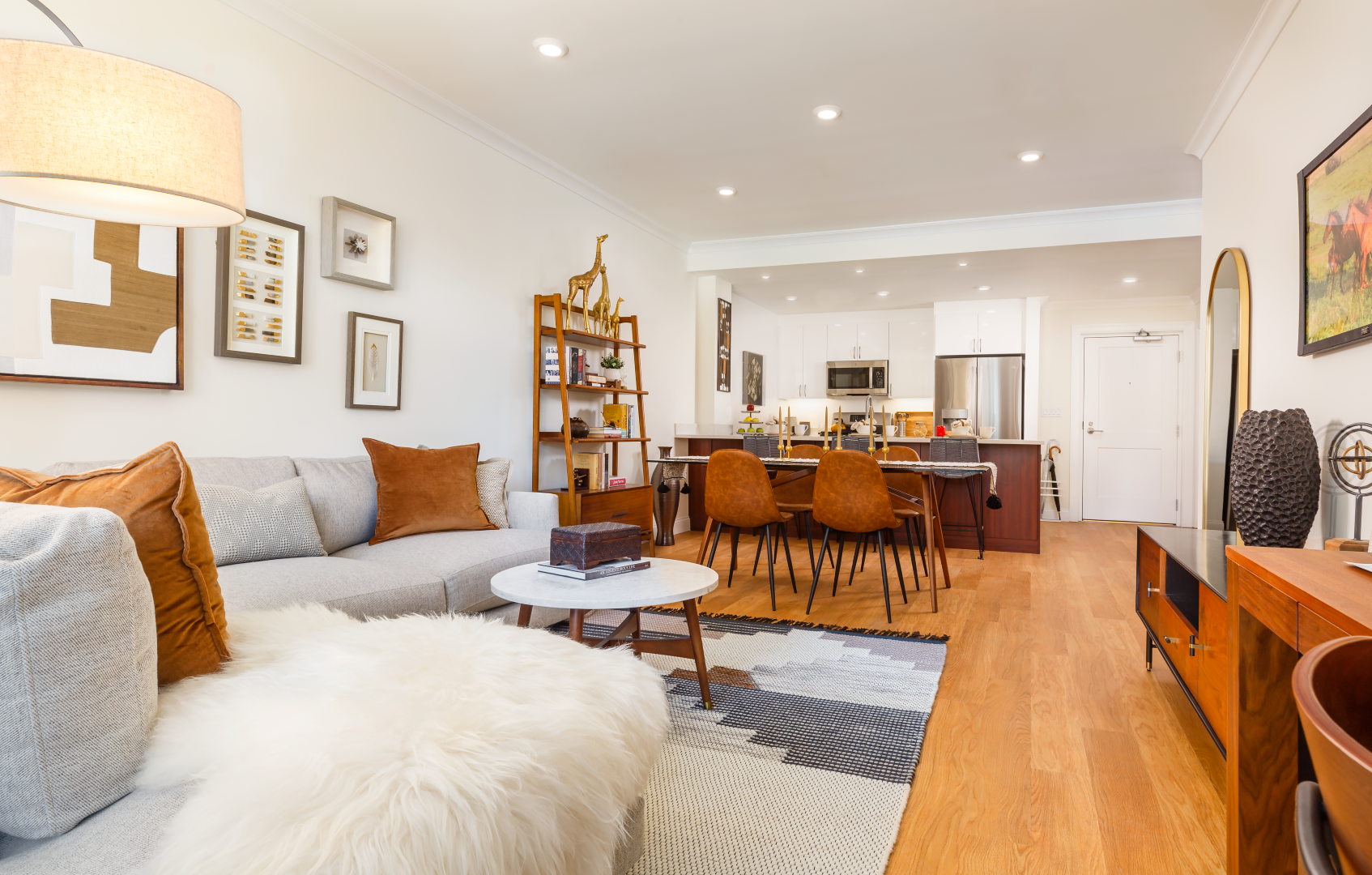 A living room with a couch , table , chairs and a television.