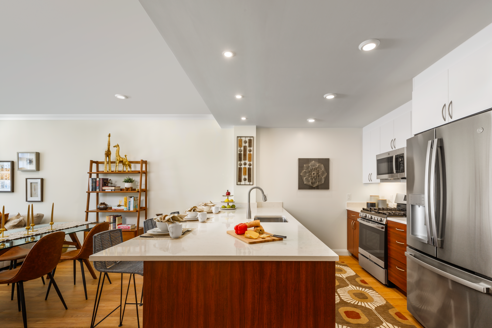 A kitchen with a large island and stainless steel appliances.