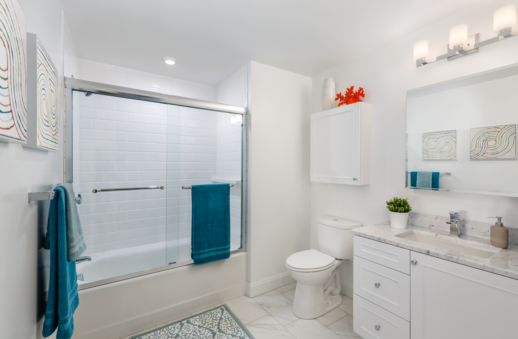 A bathroom with a toilet , sink , shower and bathtub.