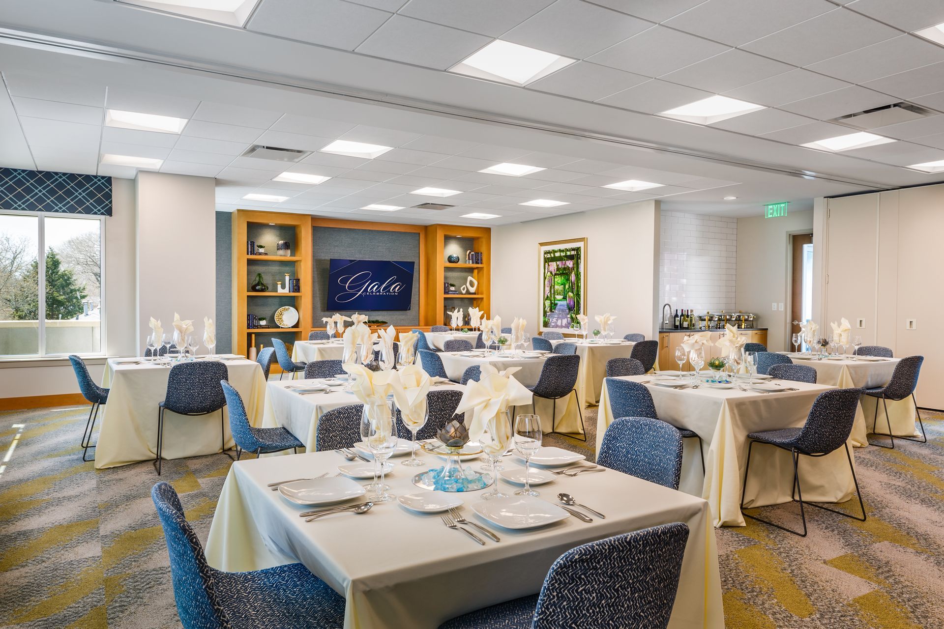 A large room with tables and chairs set up for a banquet.