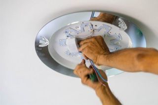 Electrician fixing ceiling fan—electrician in Sequim, WA
