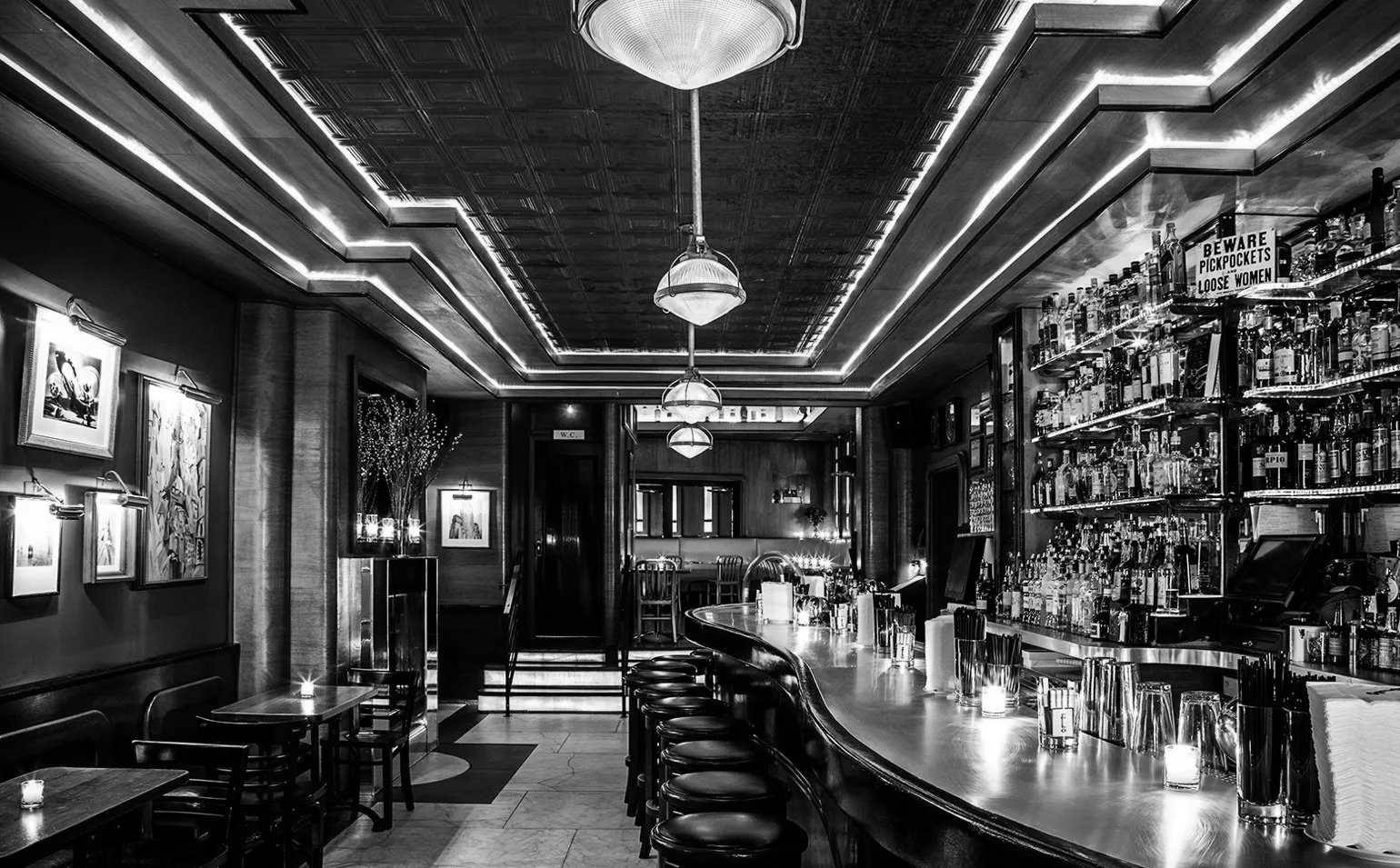 a black and white picture of a restaurant's bar area.