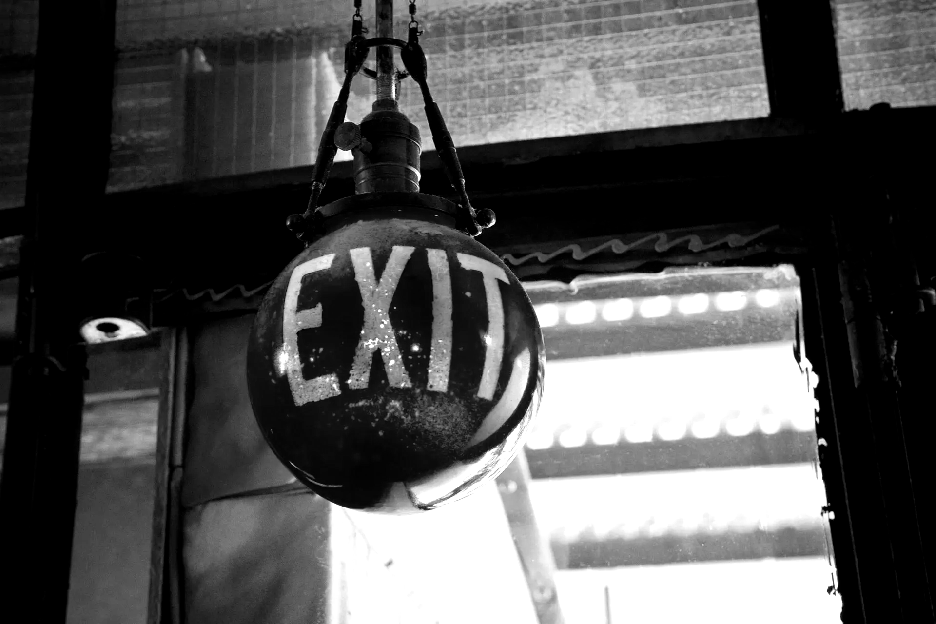 black and white photo of an exit sign in the form of a globe