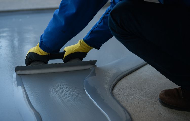 worker applying self-leveling compound