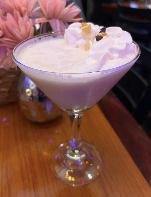 A martini glass filled with whipped cream and flowers at Mama’s Cafe Baci