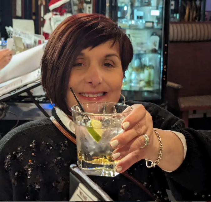 A woman is holding a drink at Mama’s Cafe Baci