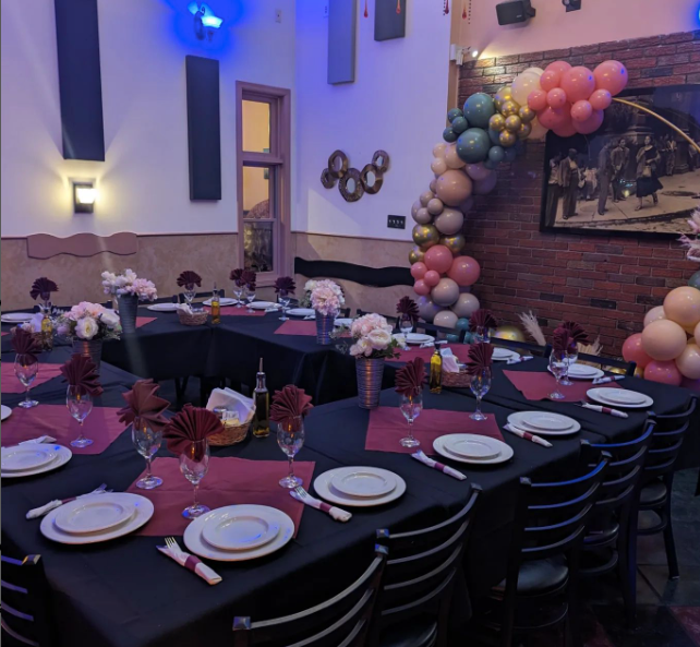 A room with tables and chairs set up for a party at Mama’s Cafe Baci