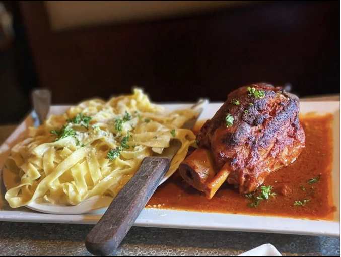 A plate of food with noodles and meat at Mama’s Cafe Baci