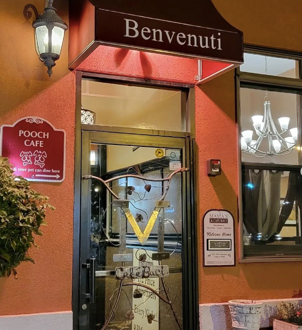 A restaurant with a sign that says benvenuti