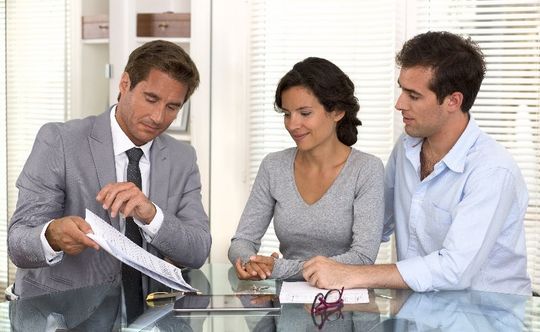 Couple consulting with insurance agent
