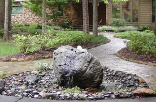 Bubble Rock and decorative concrete walkway photo - Watering System in Colorado Springs, CO