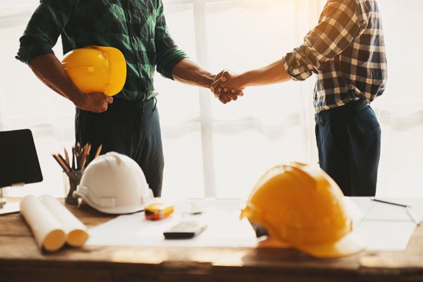 employer hiring new construction worker shaking hands