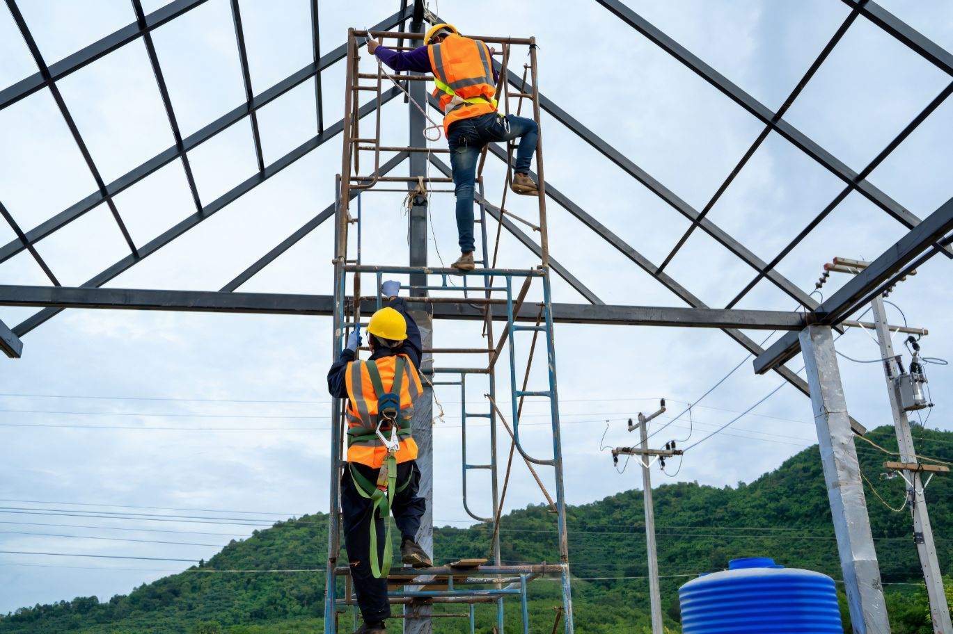 Construction Worker Wearing Safety Harness On Steel Structures — Cemak Constructions in Forster-Tuncurry, NSW