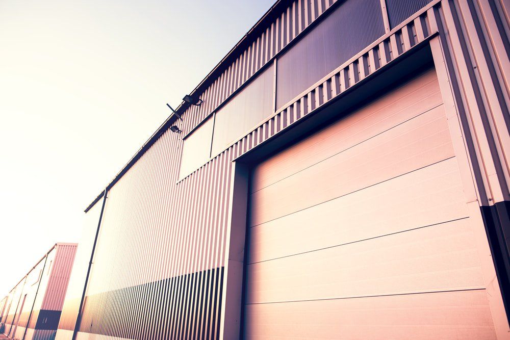 A Large Warehouse with A Large Garage Door — Cemak Constructions in Port Macquarie, NSW