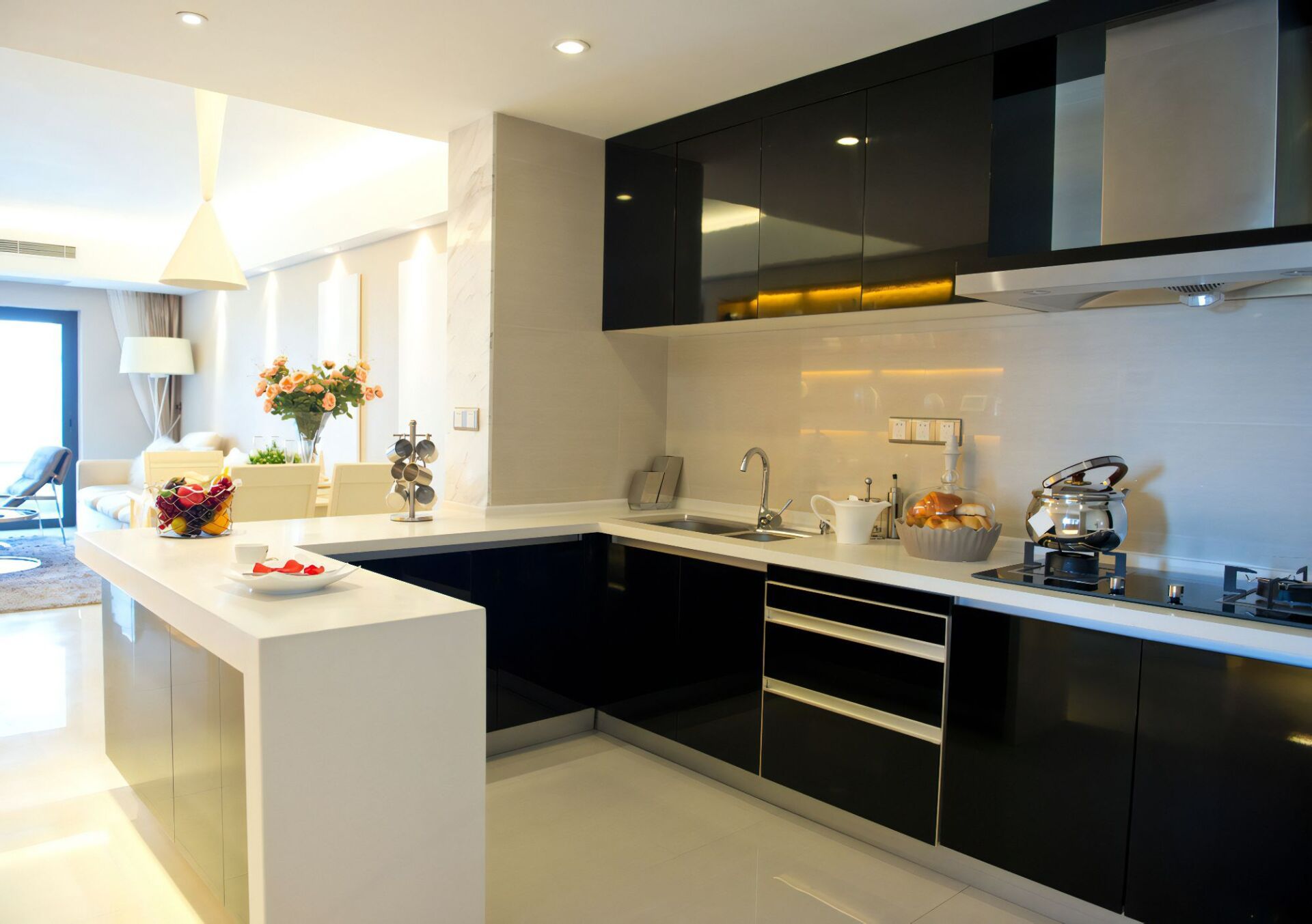A Kitchen with Black Cabinets and White Counter Tops — Cemak Constructions in Laurieton, NSW