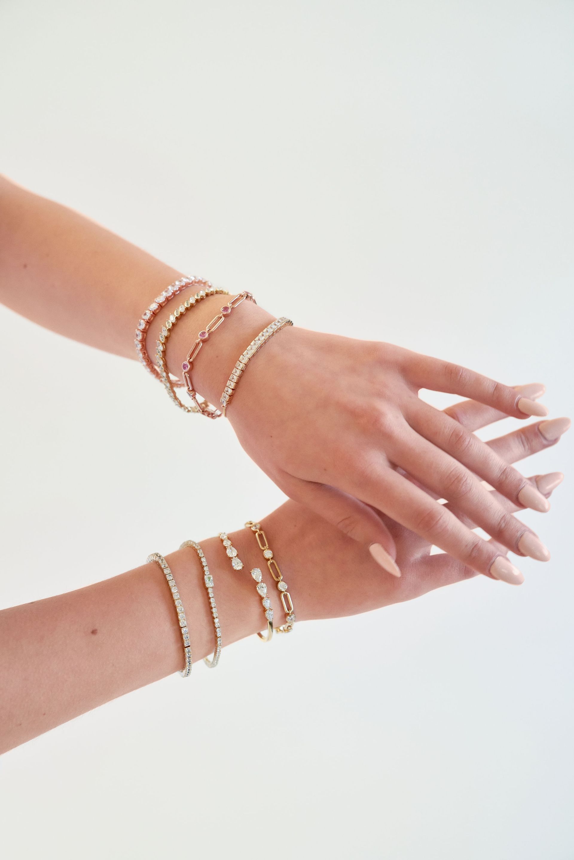 A woman is wearing a lot of bracelets on her wrist.