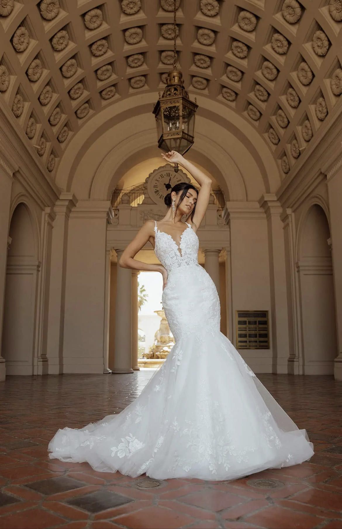 A woman in a wedding dress is standing in a building.