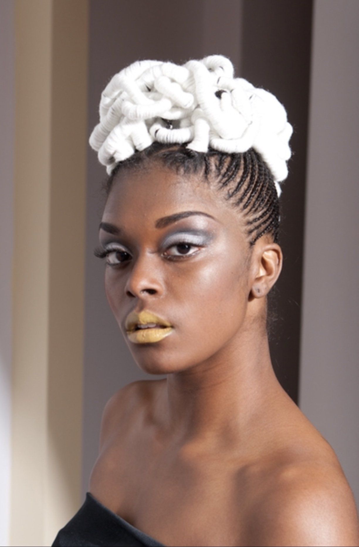 A woman with a bun in her hair and yellow lips