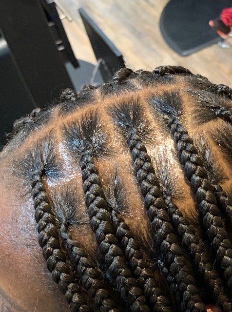 A close up of a person 's braids on their head