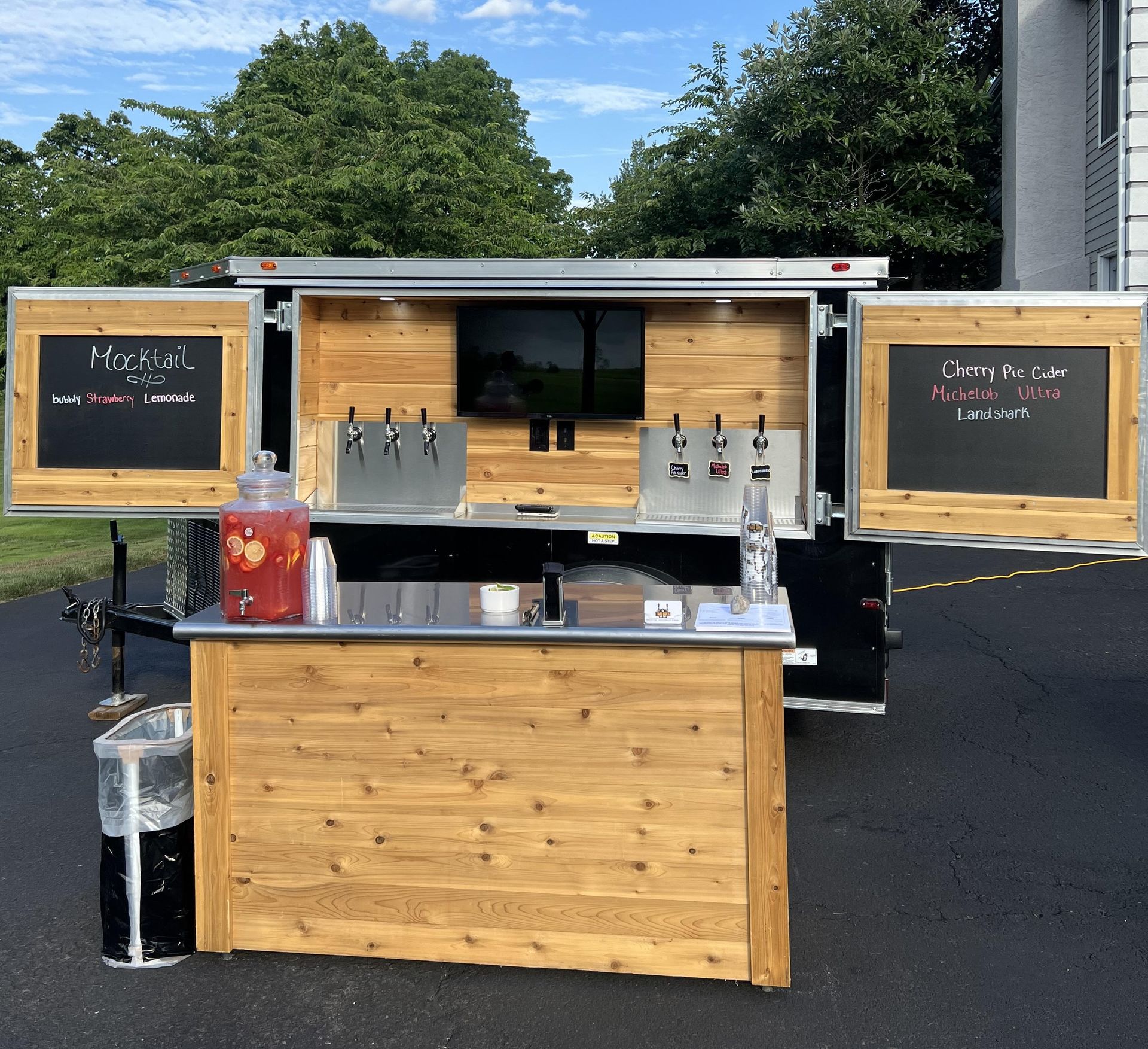 A wooden bar with a chalkboard that says 