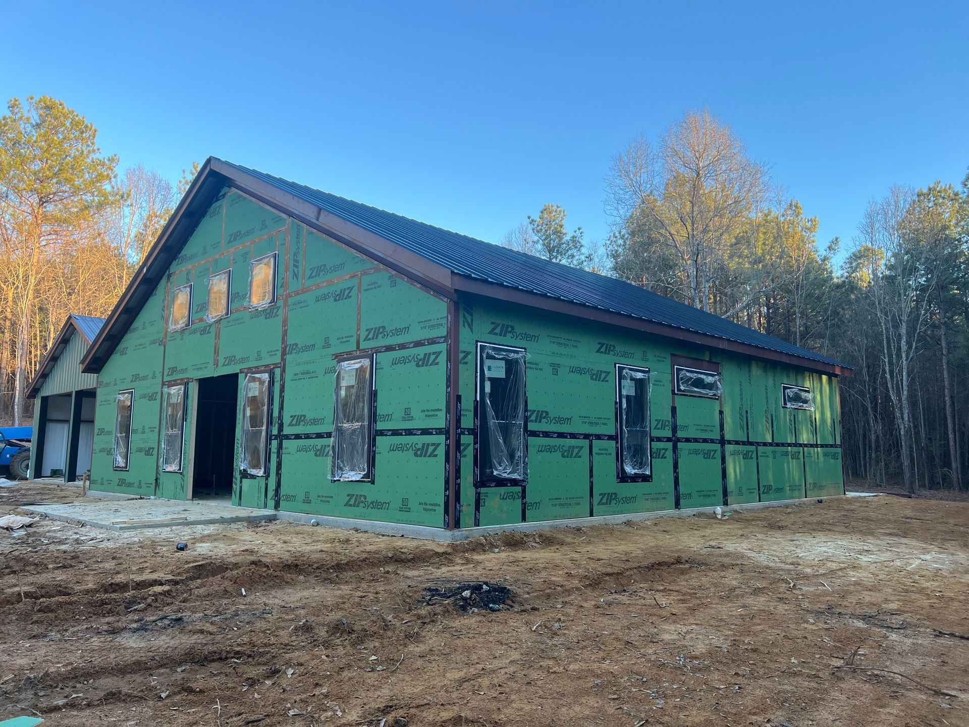 Living room with stone fireplace, hardwood floors, and double doors to outside.