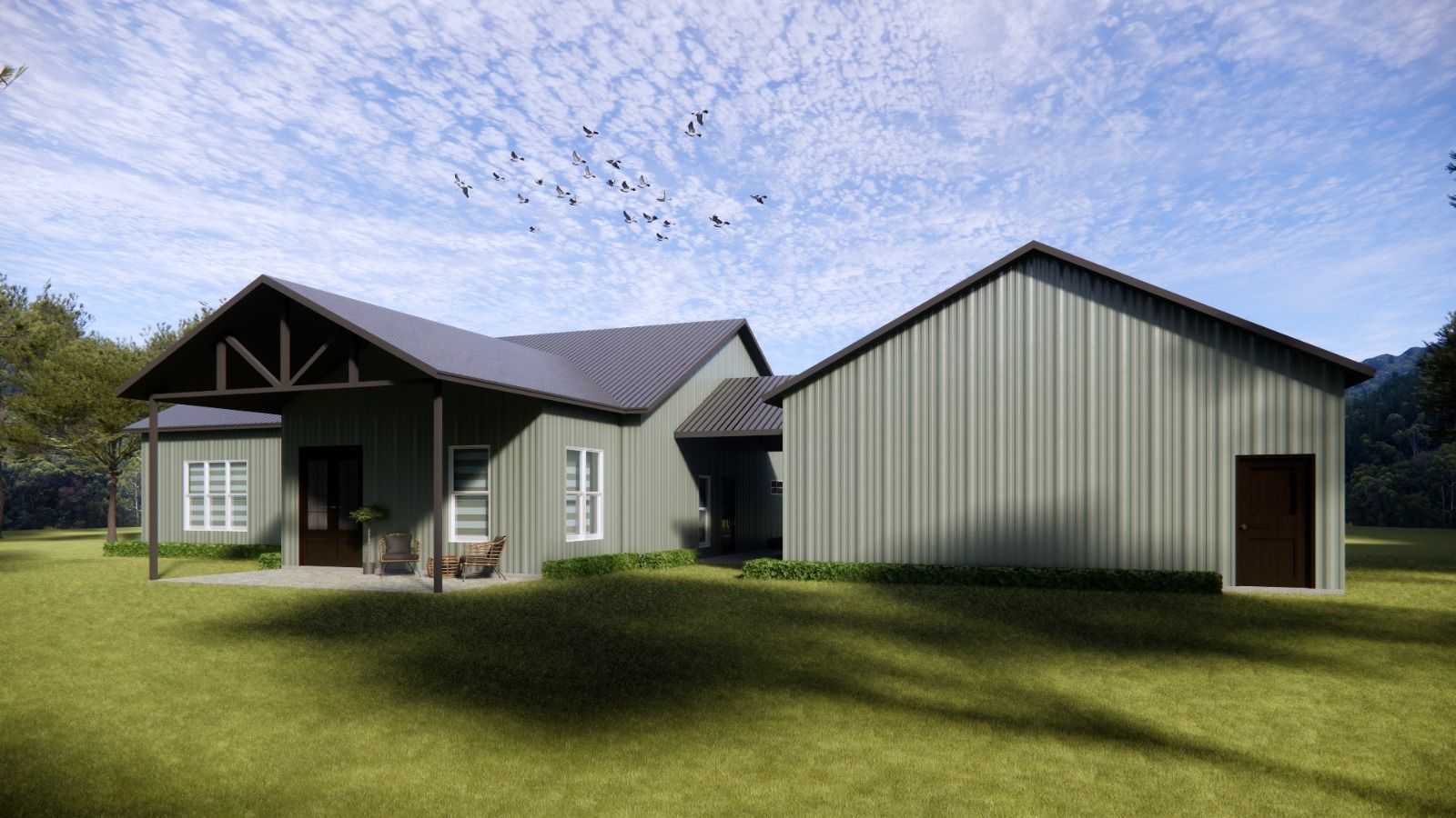 A green house with dark roof and detached garage on a grassy lawn, blue sky overhead.