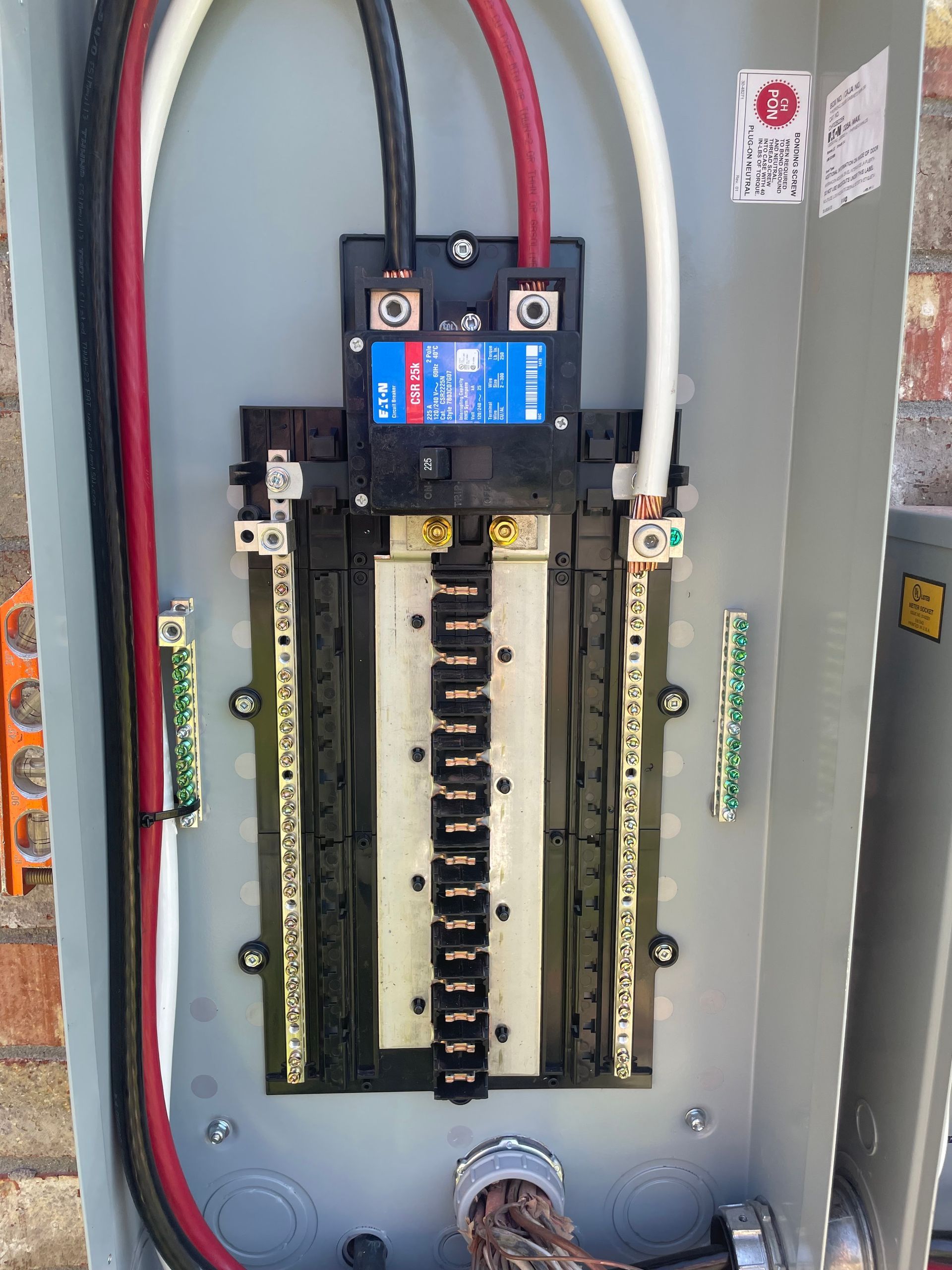 A close up of a electrical box with wires coming out of it.