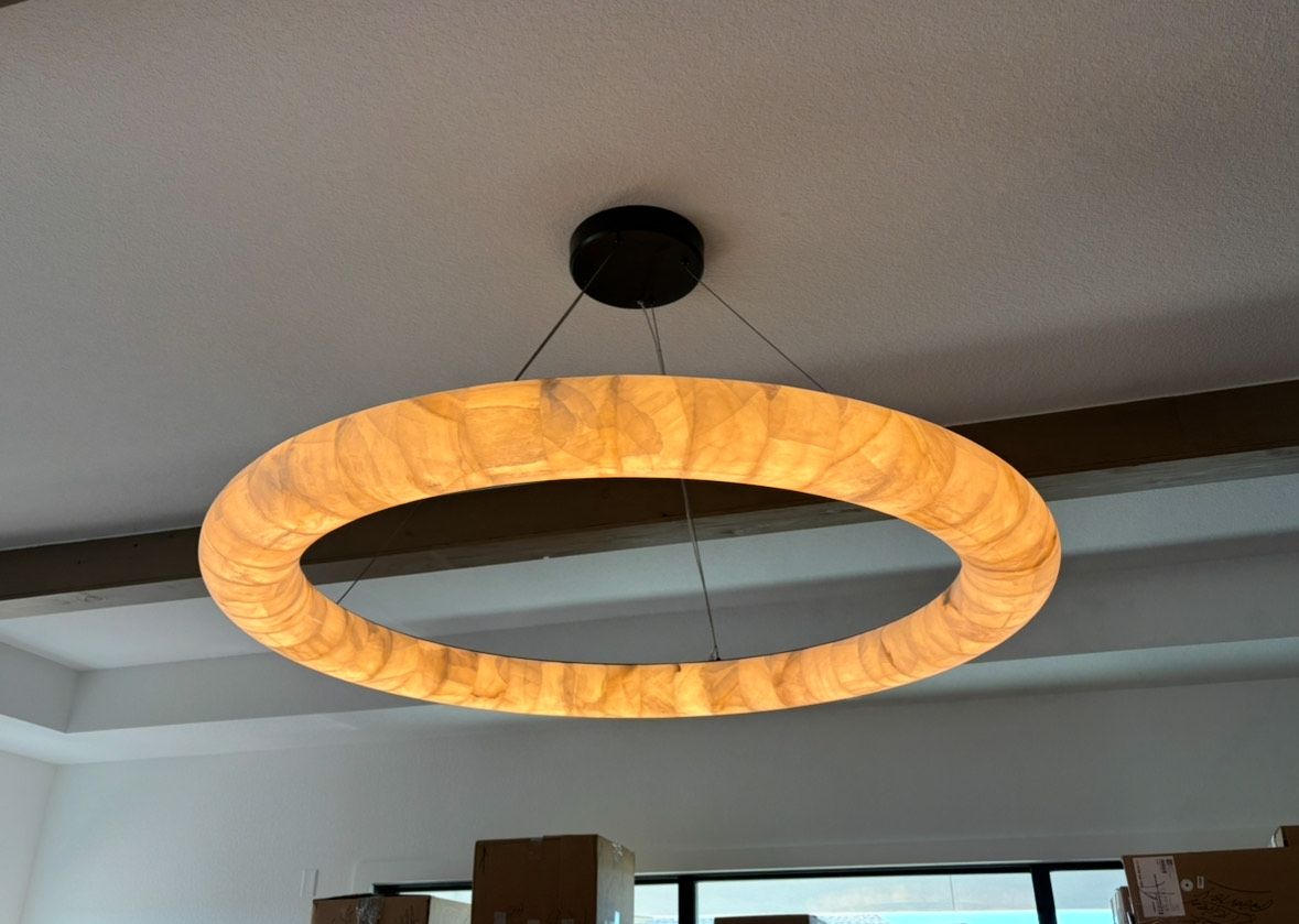 A circular light hanging from the ceiling in a room