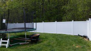 Trampoline in front of newly installed fence