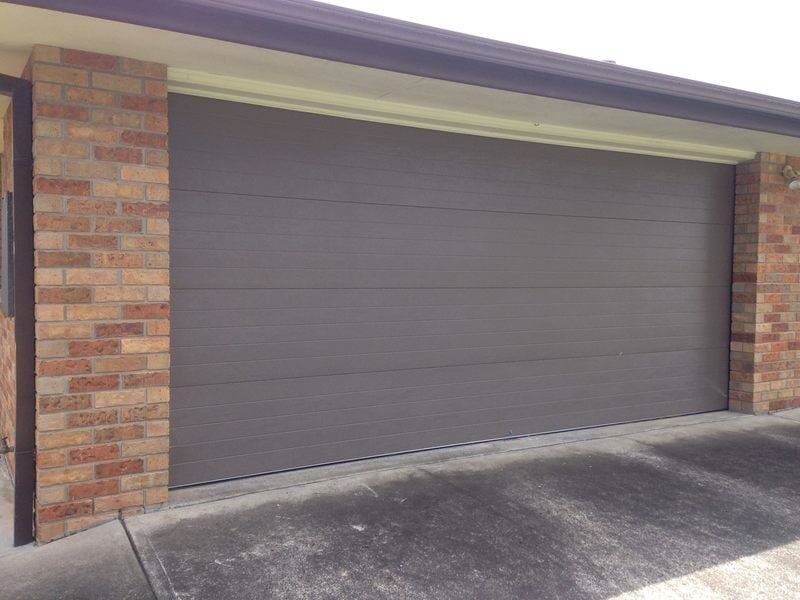 Brown garage door, white background — Designs in Taree, NSW