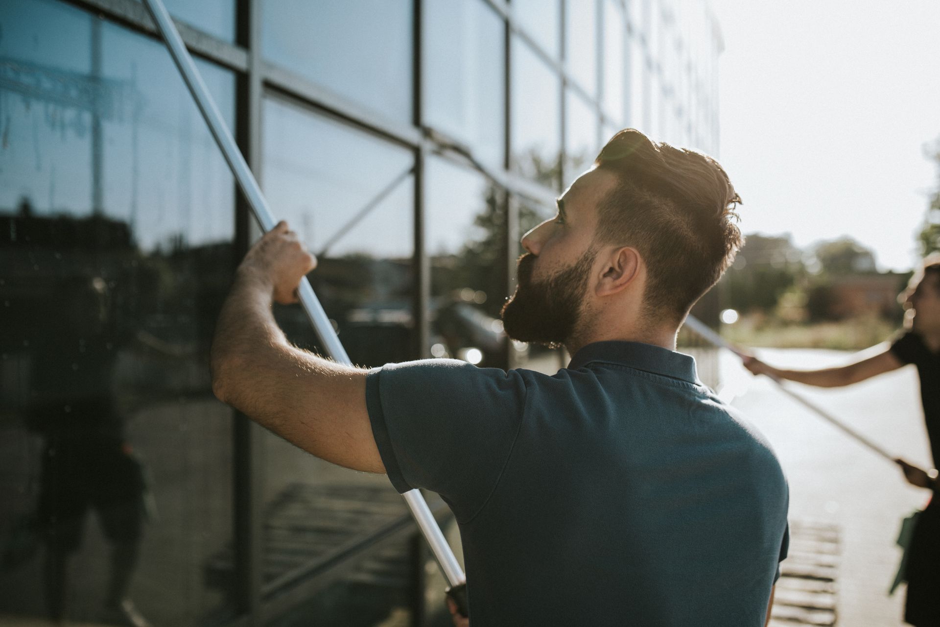 White floor in a room, with a dark gray baseboard and a dark object on the right side.
