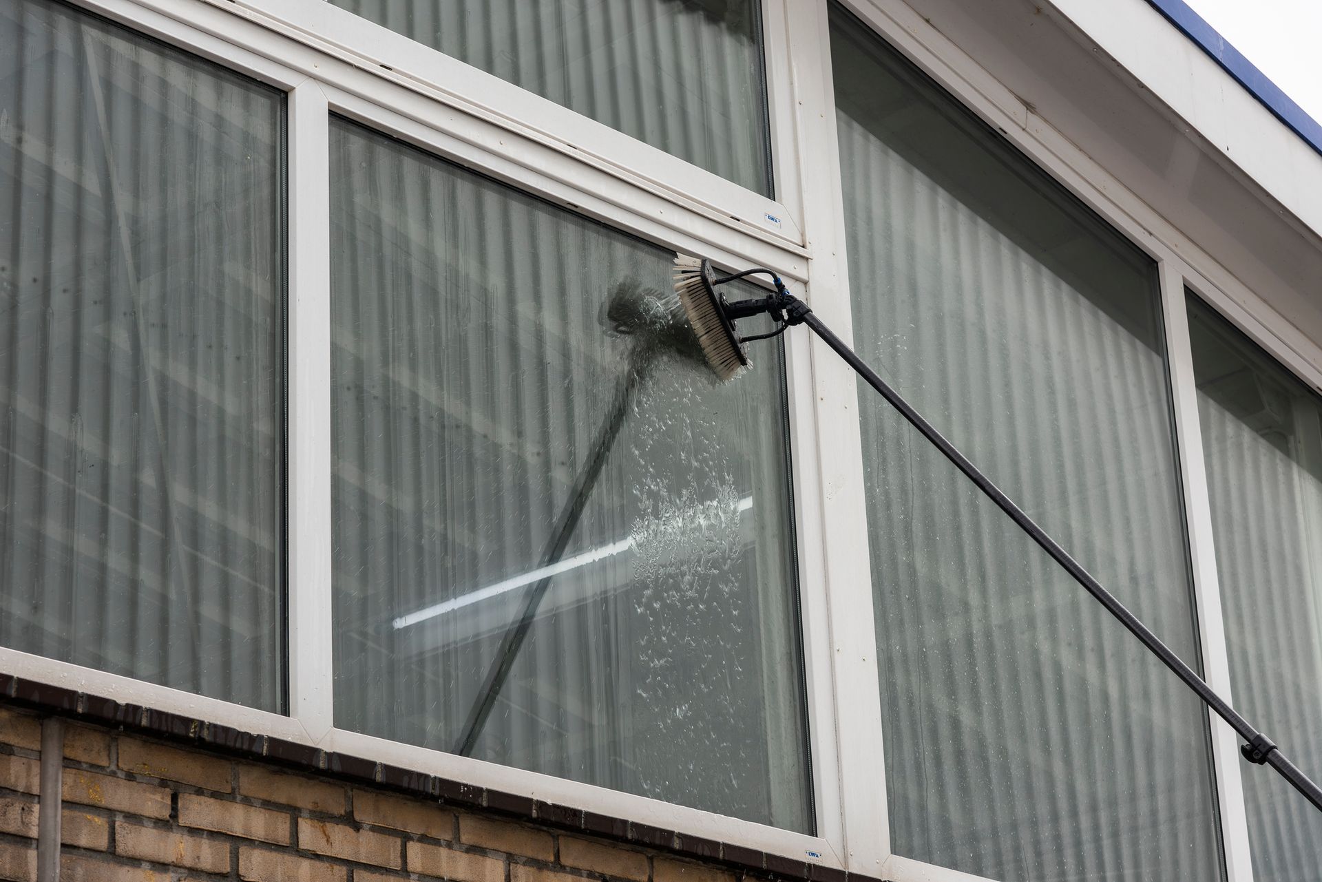 Light gray, textured flooring with a visible vent in a room.