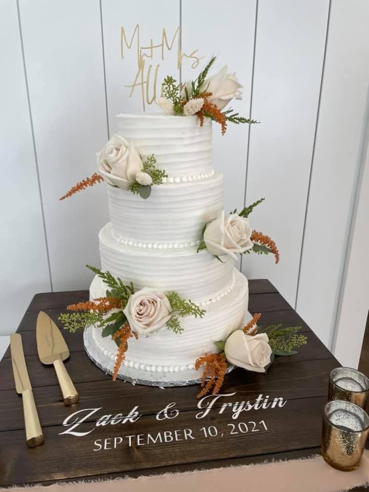 four tier wedding cake on wooden custom cake stand