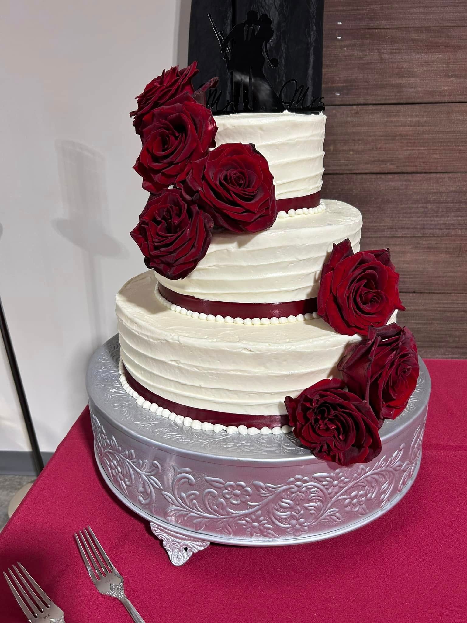 wedding cake with red flowers