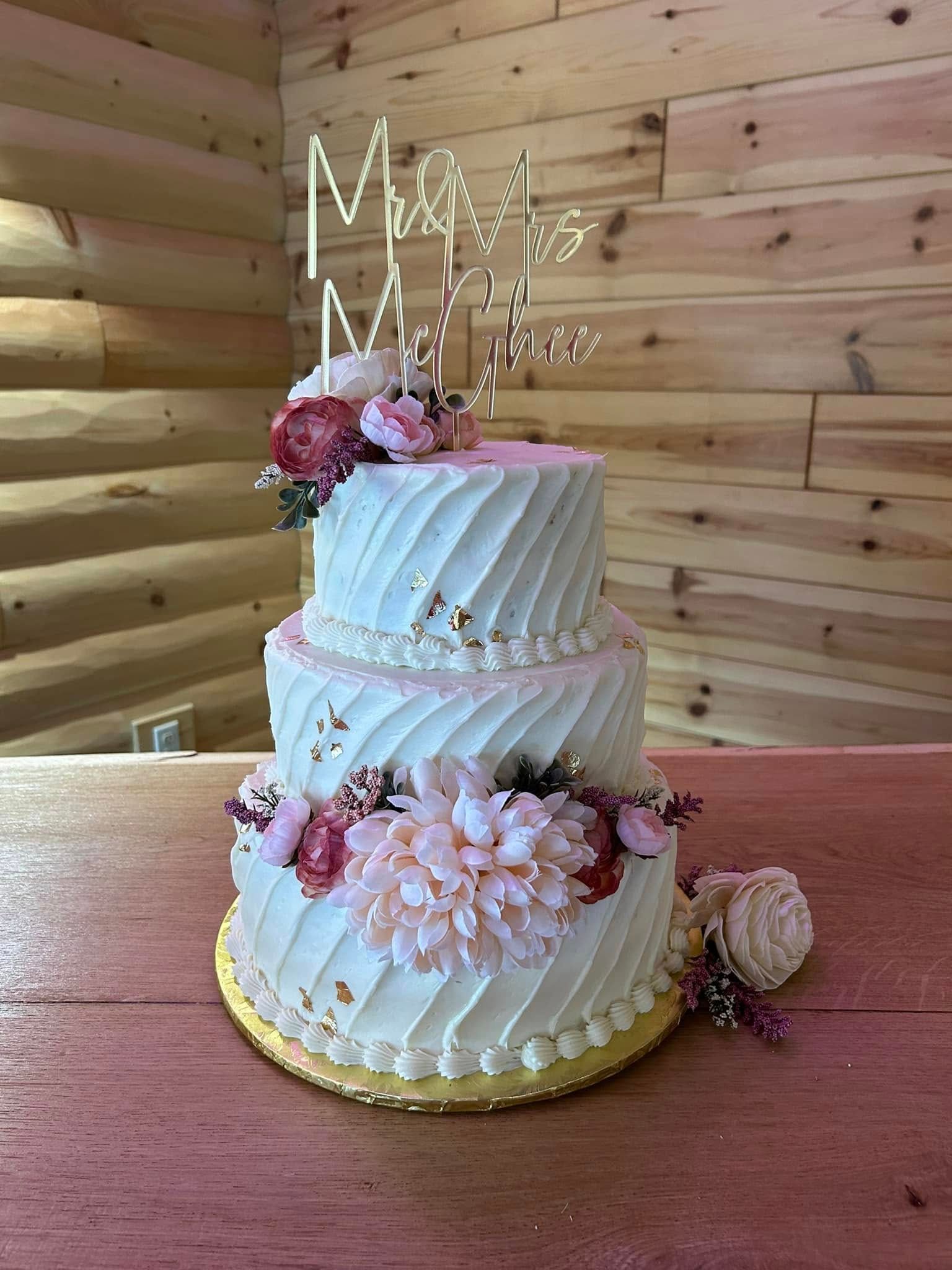 three tier wedding cake with pink flowers