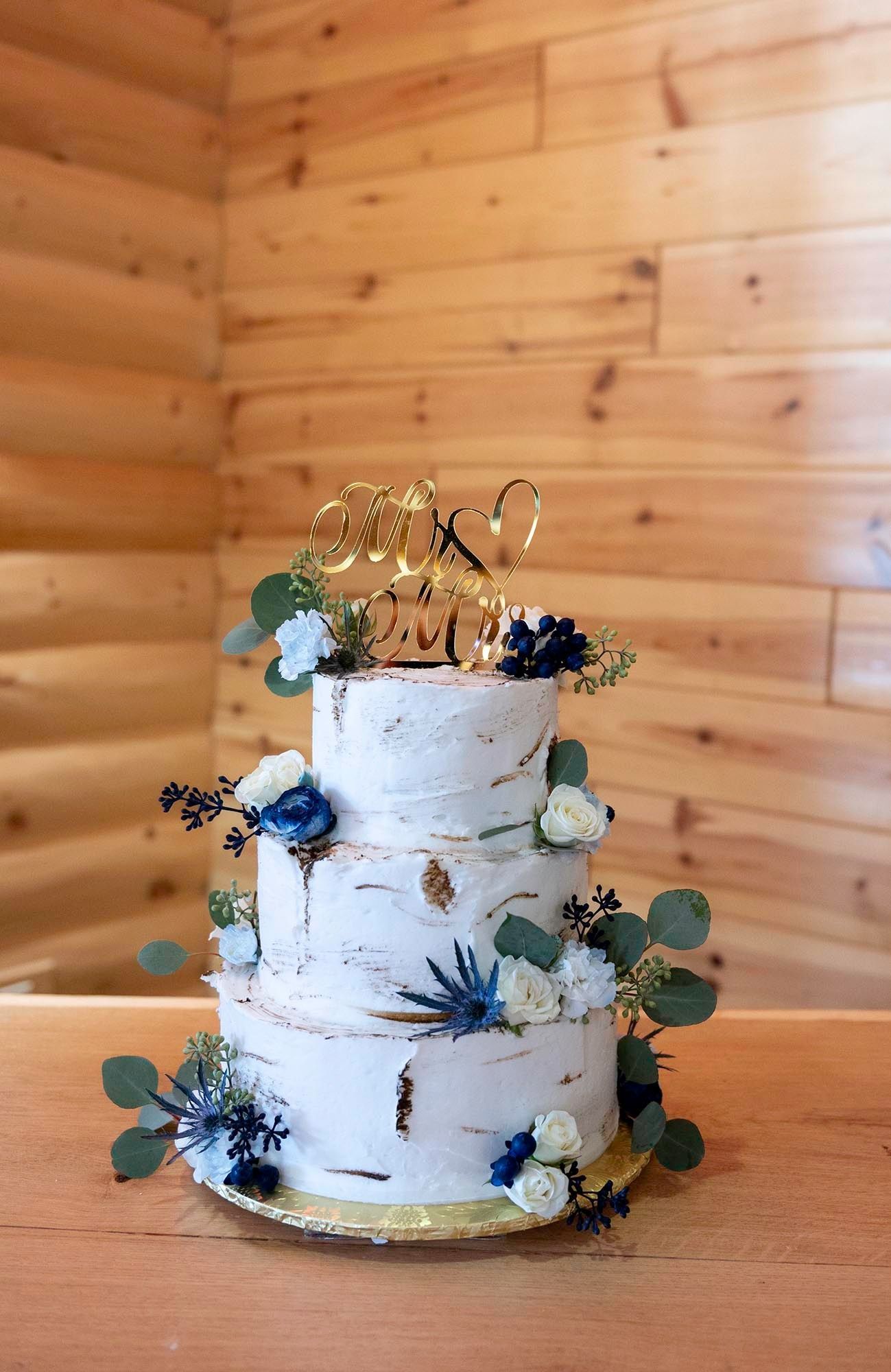 three tier wedding cake with blue flowers