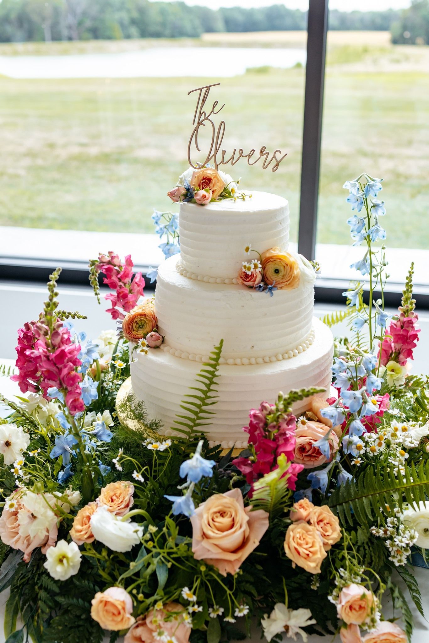 wedding cake with colorful wedding flowers