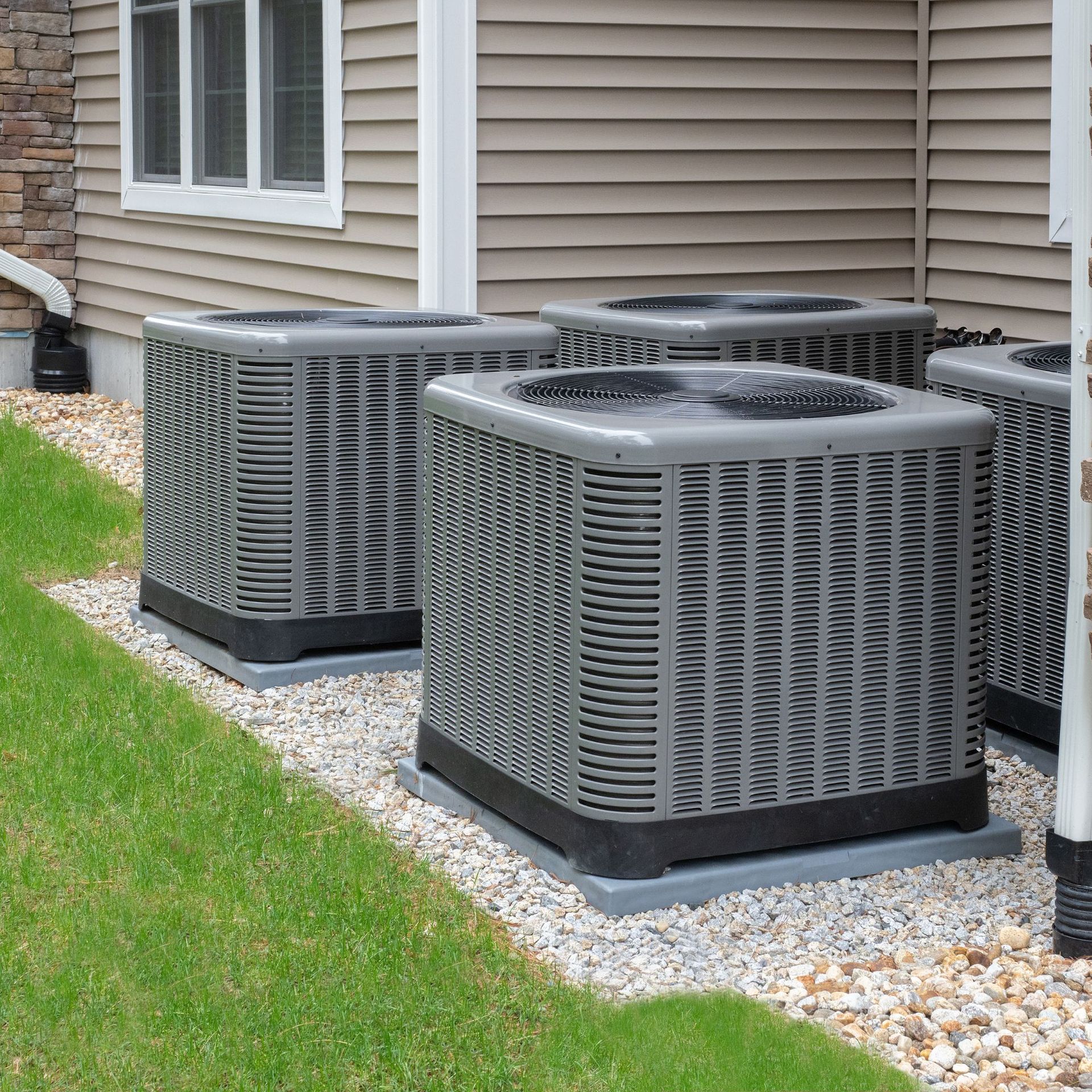 CC Air Services LLC - Three air conditioners are sitting in front of a house.