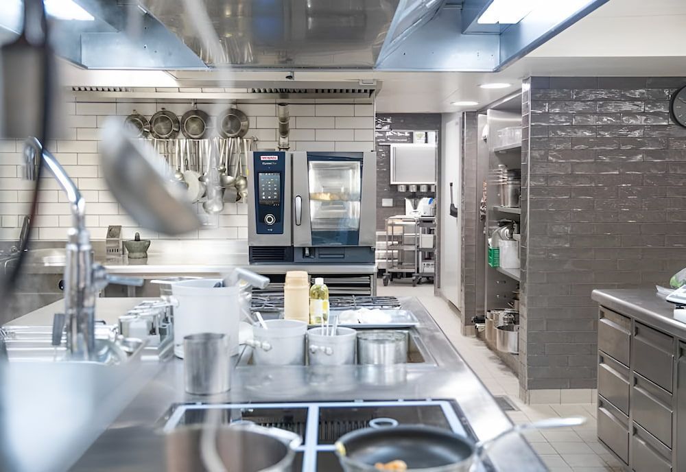 A Kitchen With a Lot of Pots and Pans on the Stove — Darwin’s Gas Man in Marrara, NT