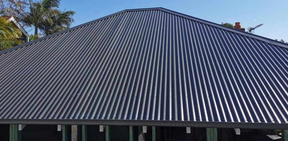 A close up of a black corrugated metal roof on a house.