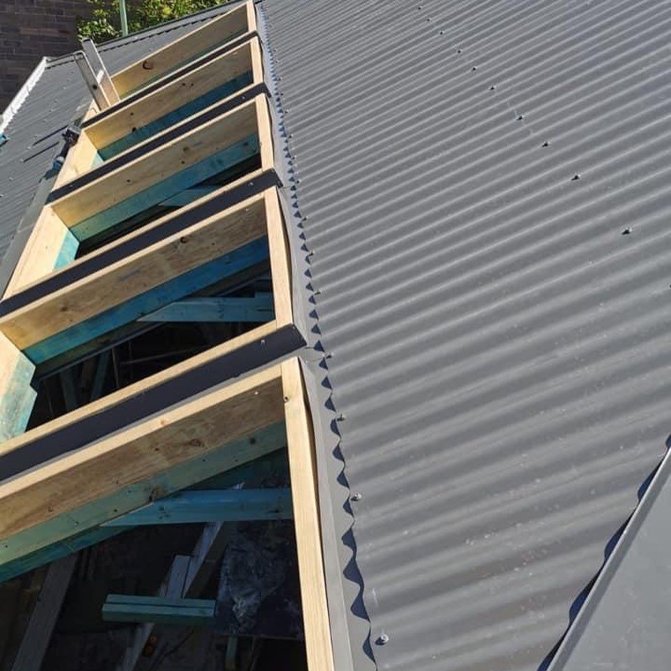 A close up of a roof with wooden beams on it