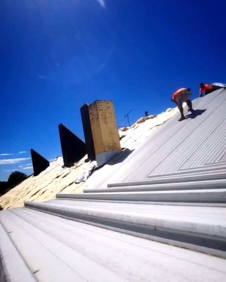 A man is working on the roof of a building